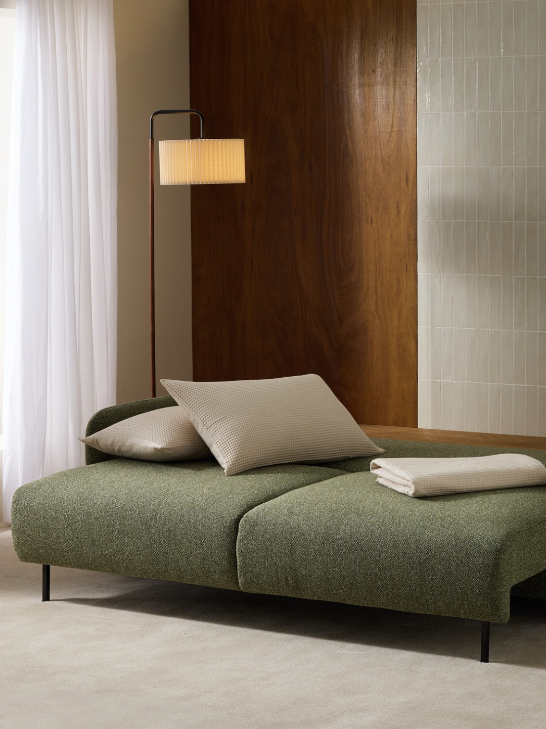 A green three-seater sofa bed from Habitat