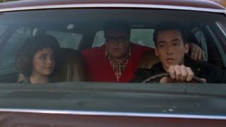 John Cusack driving a car with two other people in it with him in Better Off Dead.