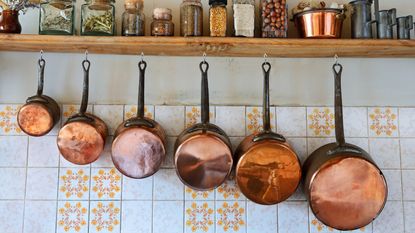 copper pans in a rustic kitchen