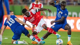 Malang Sarr and Thomas Partey fight for the ball