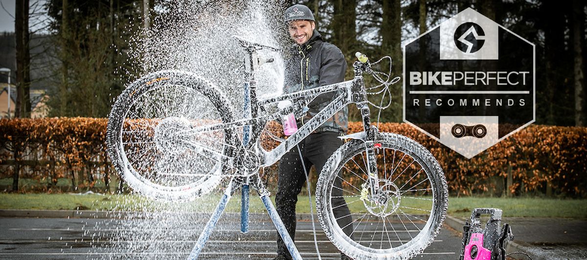 A mountain bike being cleaned with a pressure washer