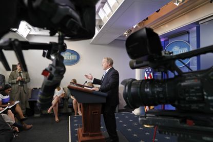 Cameras are pointed at Sean Spicer during an off-camera briefing on June 26.