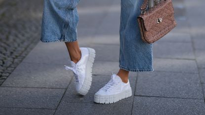 woman wearing chunky 90s style sneakers