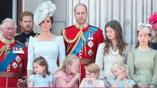 Members of the Royal Family (L-R) Britain's Prince Charles, Prince of Wales, Britain's Prince Harry, Britain's Catherine, Duchess of Cambridge (with Princess Charlotte, Savannah Phillips, Prince George) and Britain's Prince William, Duke of Cambridge, stand on the balcony of Buckingham Palace to watch a fly-past of aircraft by the Royal Air Force, in London on June 9, 2018