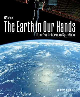 a book cover depicting a blue planet Earth beneath the words "The Earth in Our Hands"
