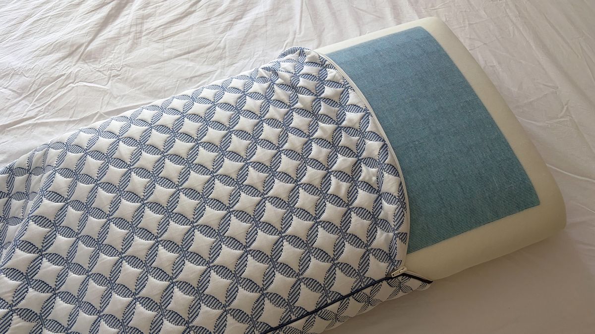 The Helix Cooling Memory Foam pillow fill, halfway out of the unzipped cover in our reviewer's bedroom