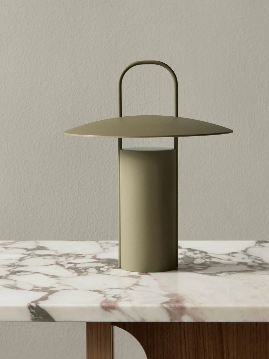 A khaki green portable lamp from Audo Copenhagen