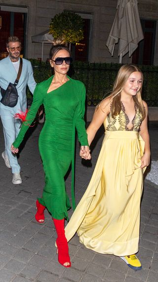 Victoria Beckham in a green dress and red shoes