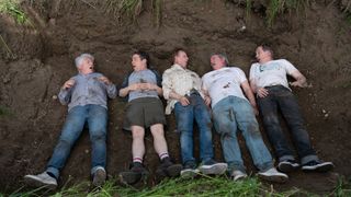 The cast of the Kids in the Hall take part in a sketch where they find each other lying in a shallow grave