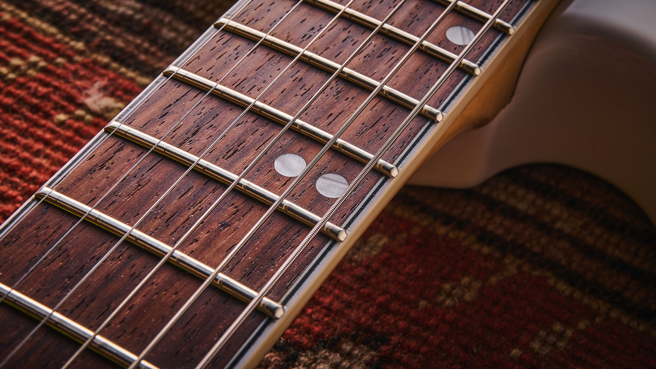 Vintage REVO Astrostar: the retro-inspired electric has three single-coils, a white finish with cream pickguard and is photographed in close-up.