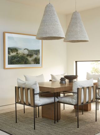 Neutral dining room with rattan pendant lights and wood table