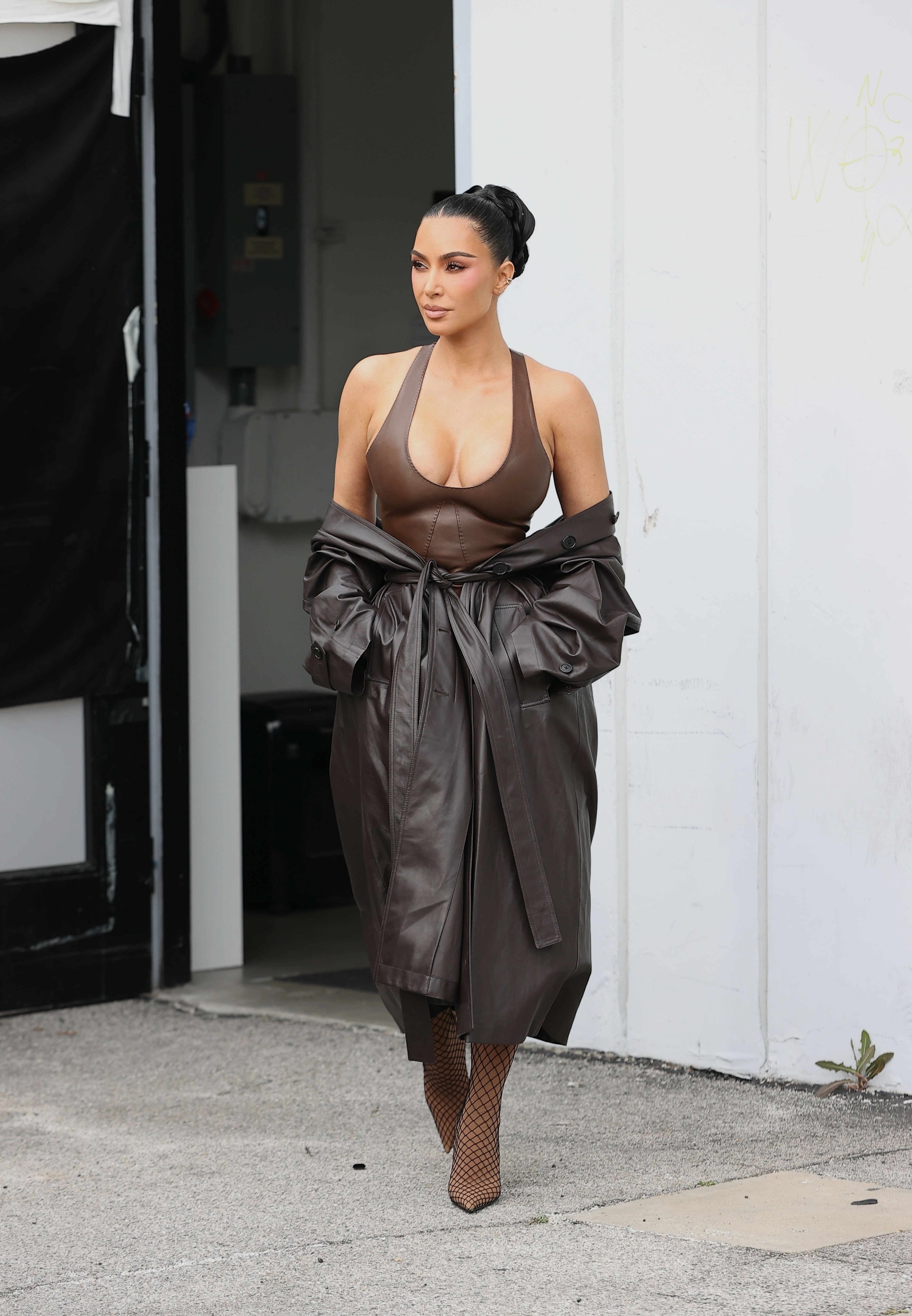 Kim Kardashian was spotted after a L.A. photoshoot in a leather and suede skirt set, plus the leather trench coat trend