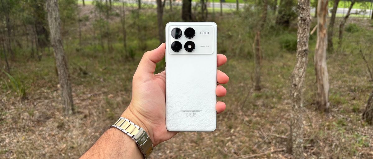 Poco F6 Pro being held outside, showcasing its back cover and camera bump