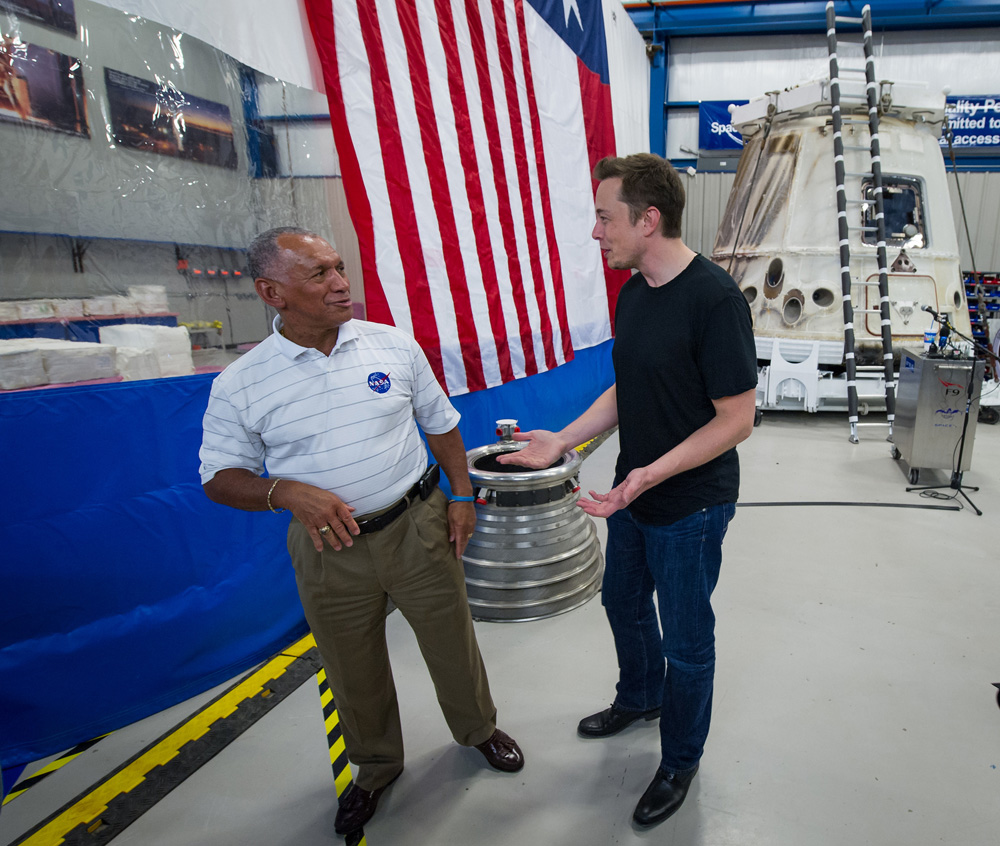 NASA Administrator Charles Bolden, left, and SpaceX CEO and chief designer Elon Musk view the company&#039;s Dragon capsule, right, in June 2012. This capsule made history several weeks earlier, becoming the first private spacecraft ever to carry supplies to t