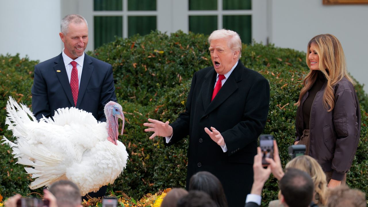Donald Trump pardons the National Thanksgiving Turkey in the White House Rose Garden alongside first lady Melania Trump