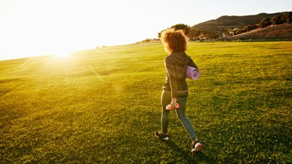 Woman walking away with exercise gear