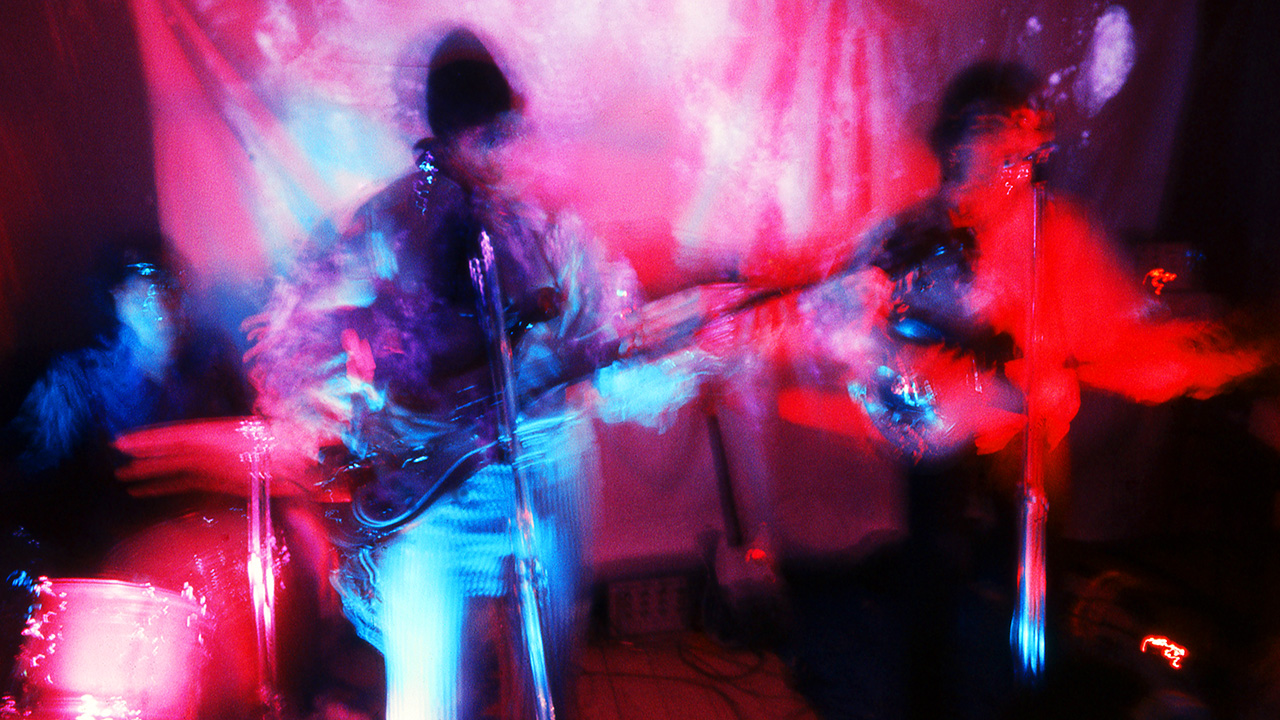 Nick Mason, Roger Waters and Syd Barrett of Pink Floyd perform under psychedelic lighting at the Architectural Association student party, London, 16th December 1966. (Photo by Adam Ritchie/Redferns)