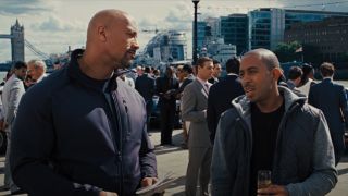 Dwayne Johnson and Ludacris looking at each other in Fast and Furious 6