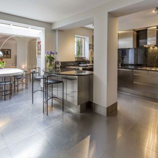 The sleek kitchen features lots of stainless steel