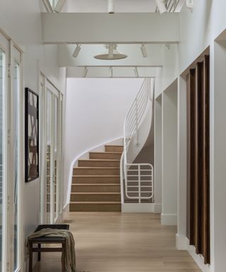 foyer with curved staircase and white walls