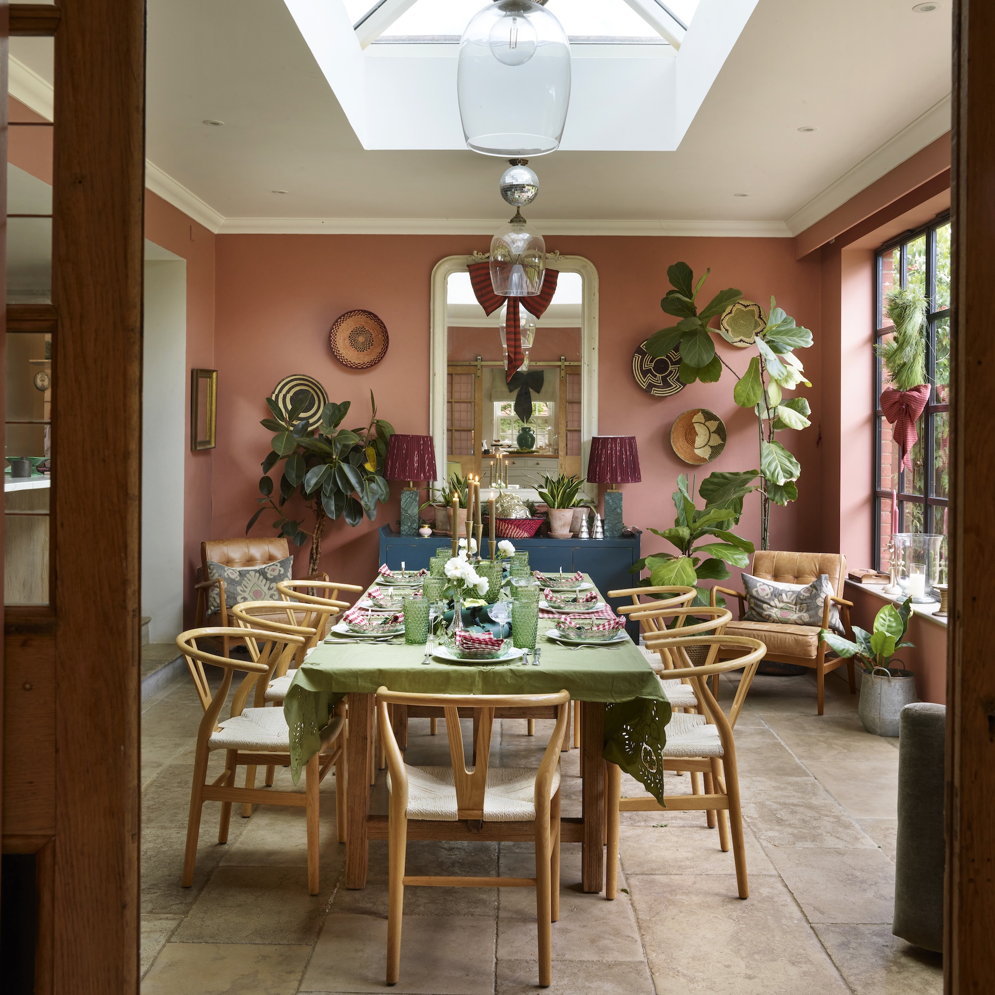 dining room with peach walls with table dressed for Christmas