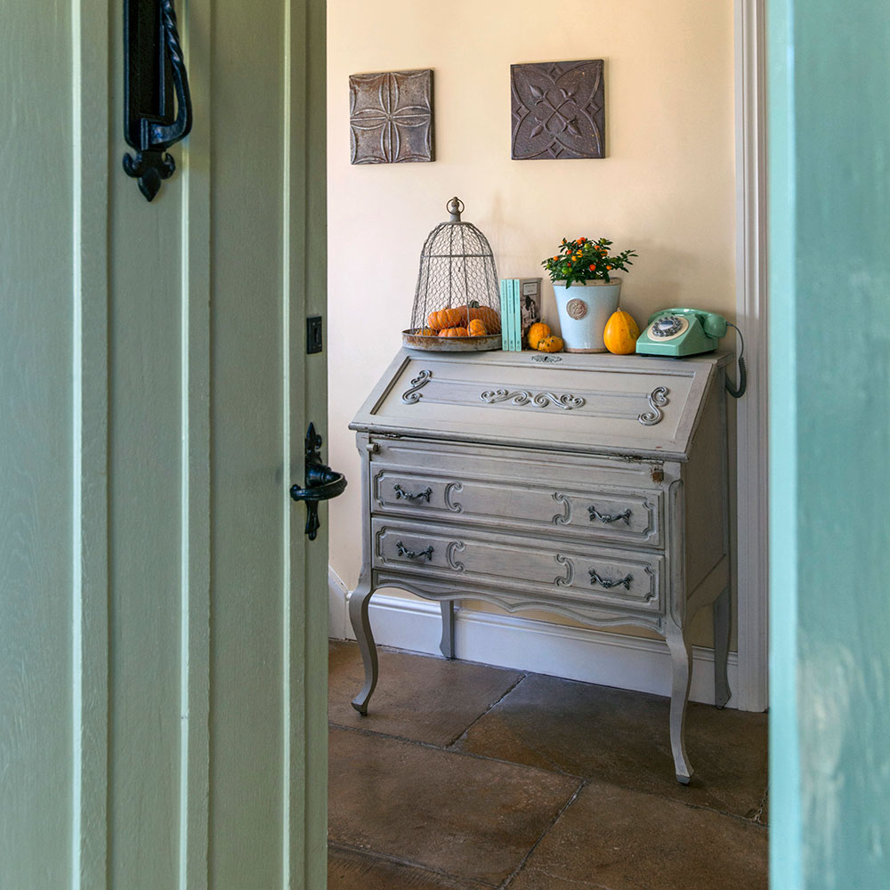 hallway with green door and telephone