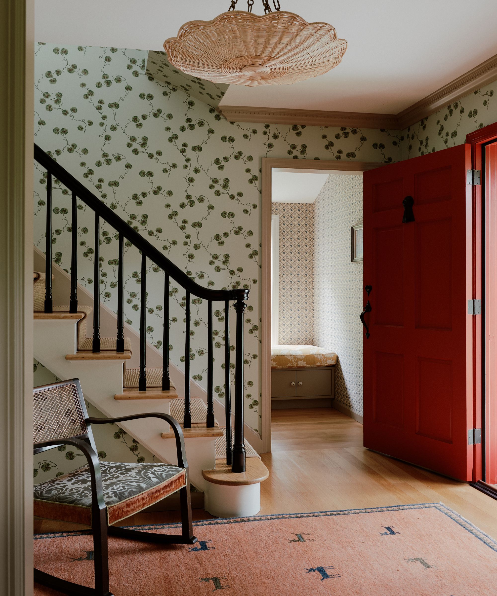 entrance hall and stairs with wallpaper and rocking chair