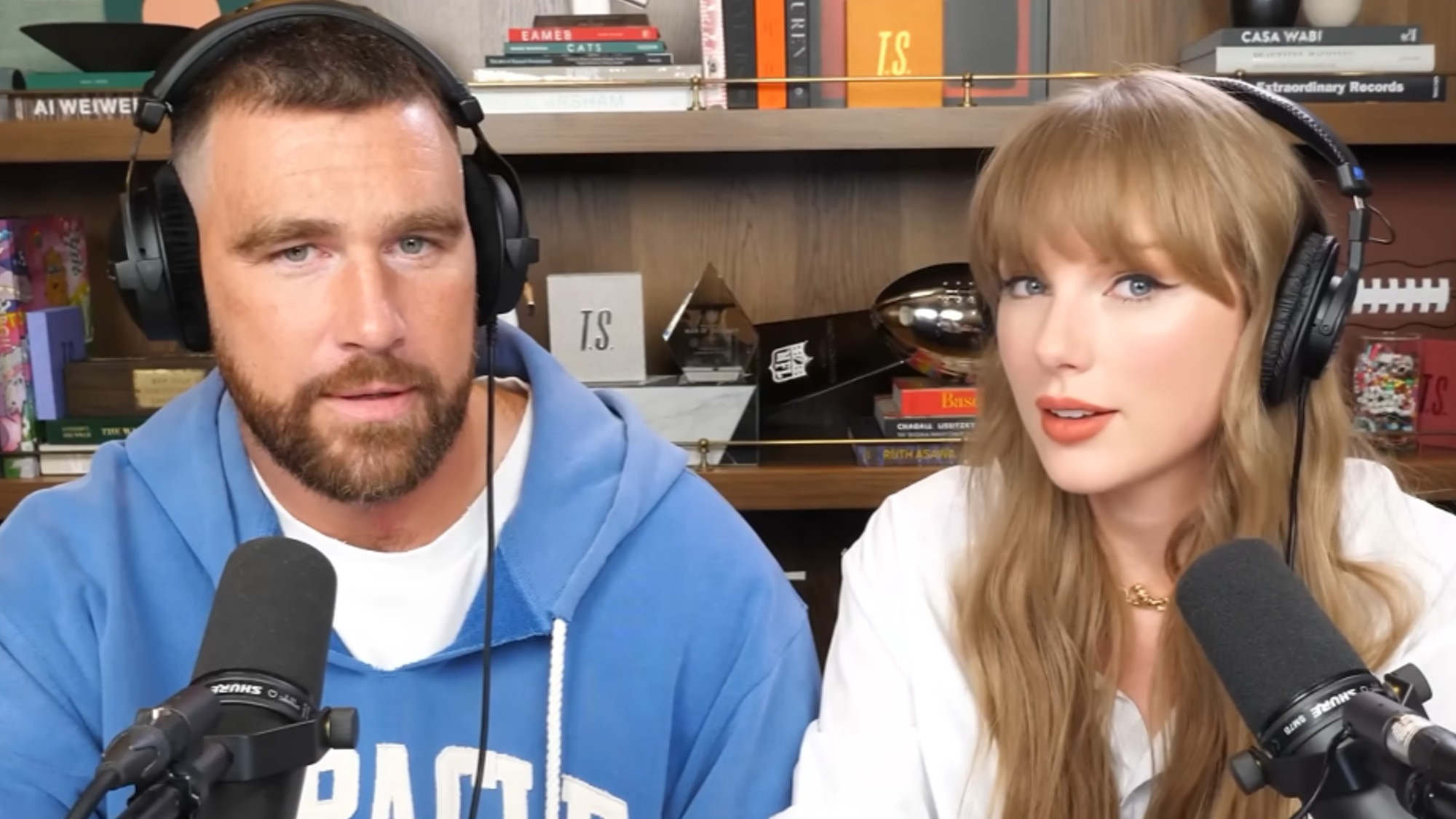 From left to right: Travis Kelce looking forward and Taylor Swift looking forward in their episode of New Heights. 