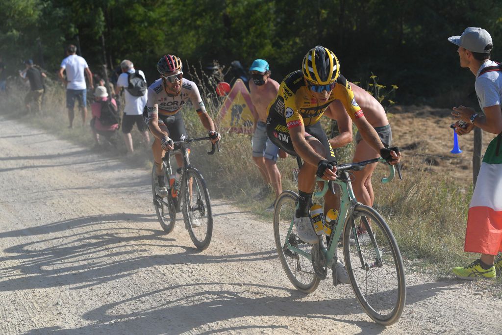 SIENA ITALY AUGUST 01 Wout van Aert of Belgium and Team JumboVisma Maximilian Schachmann of Germany and Team BoraHansgrohe Fans Dust Gravel Strokes during the Eroica 14th Strade Bianche 2020 Men a 184km race from Siena to SienaPiazza del Campo StradeBianche on August 01 2020 in Siena Italy Photo by Tim de WaeleGetty Images