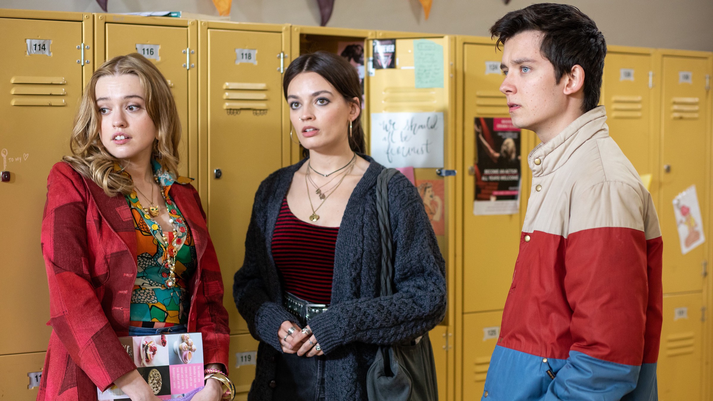 Three sixth-formers standing in front of school lockers