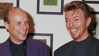 UNITED KINGDOM - CIRCA 1994: Brian Eno (L) and David Bowie attend a private view of charity exhibition "War Child: Little Pieces From Big Stars" at Flowers East Gallery in September 1994 in London, England. (Photo by Dave Benett/Getty Images) Davidbowieretro