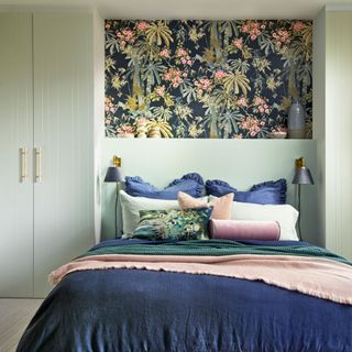 guest bedroom with green wardrobes and floral panelled wall