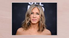 Image of Jennifer Aniston attending the 29th Annual Critics Choice Awards at Barker Hangar on January 14, 2024 in Santa Monica, California, in a white frame against a dusky pink watercolour-style background