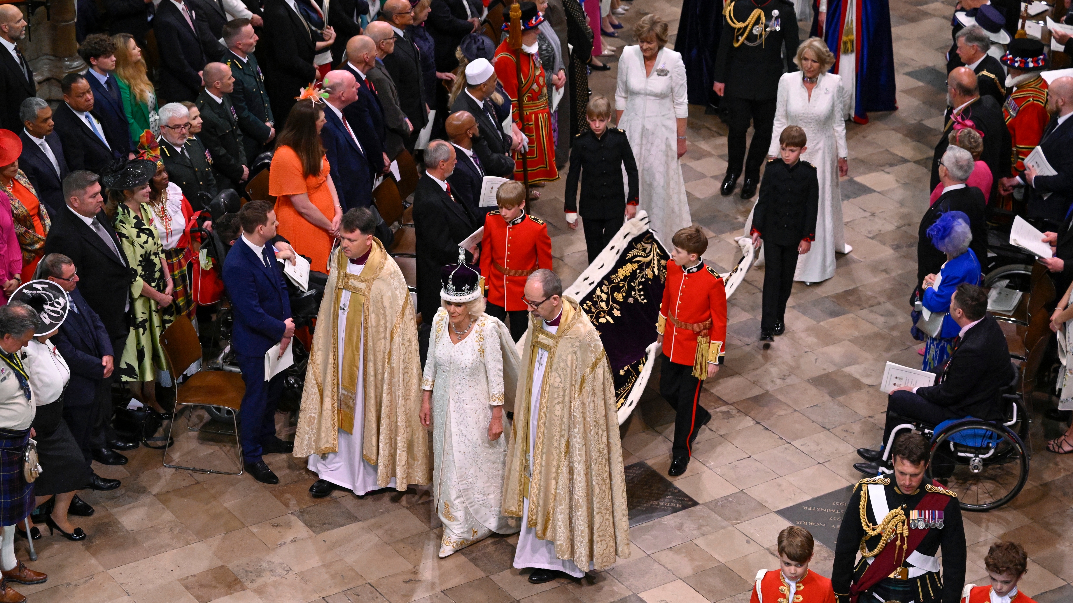 Queen Camilla departs the Coronation service with Lady Lansdowne and Annabel Elliot behind her