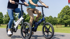 2 GoCycle G4 ebikes being ridden by a man and woman