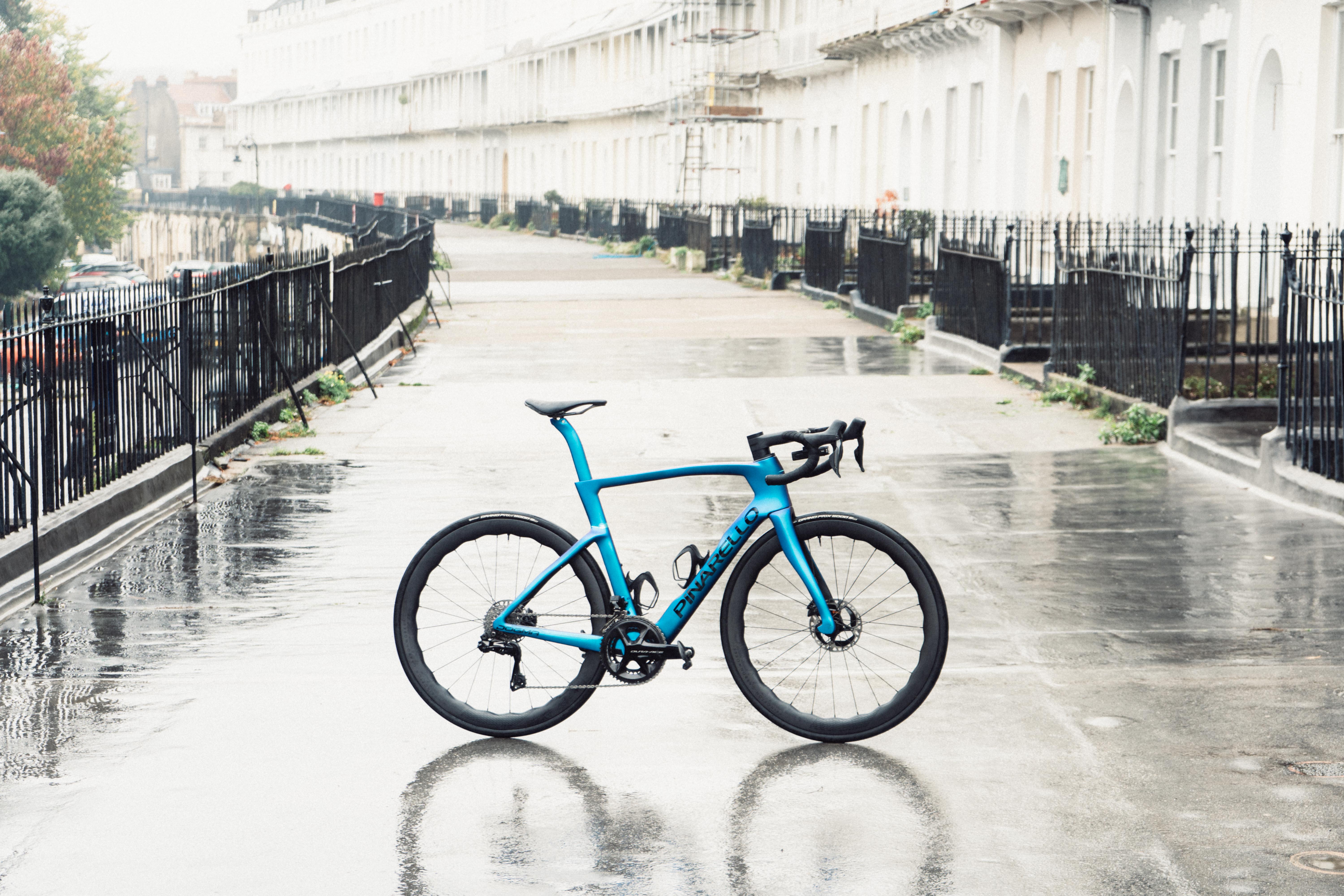 A blue bike stood on an old crescent of houses