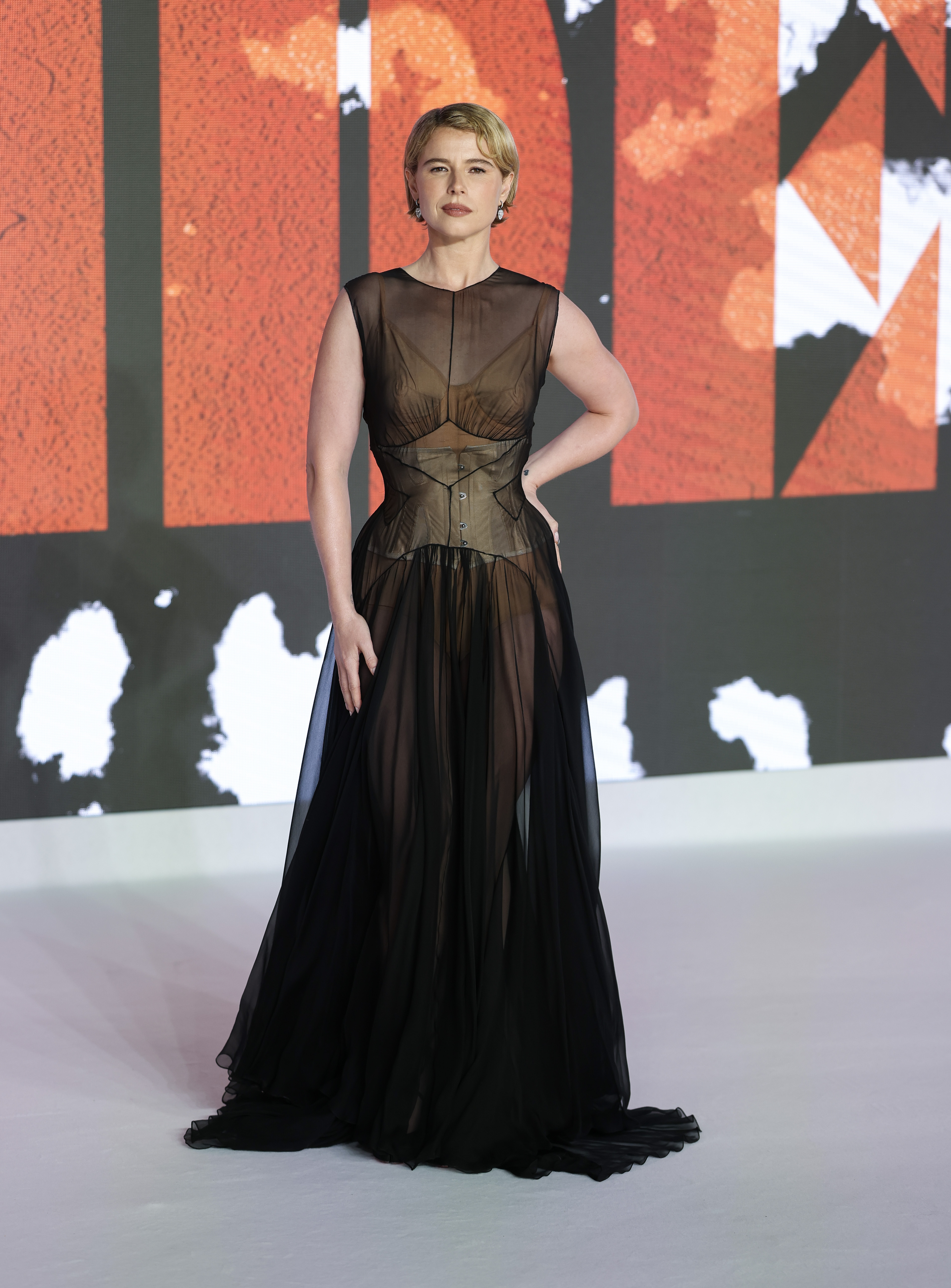 Jessie Buckley attended the premiere of The Bride in a sheer Maison Margiela naked dress and a peekaboo corset