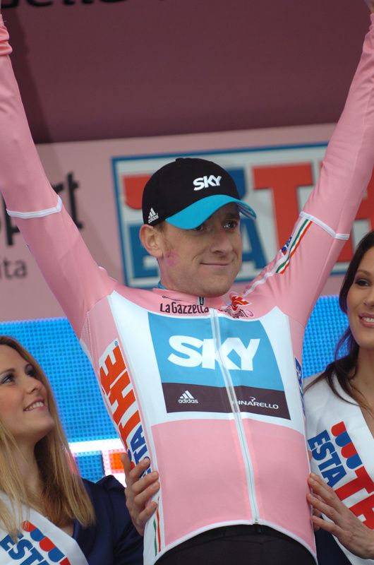 Bradley Wiggins celebrates wearing the first maglia rosa of 2010 after his time trial victory