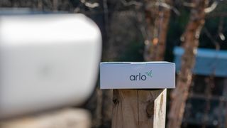 A camera looking at an Arlo-branded box