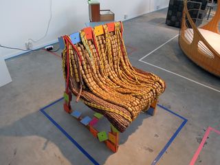 View of the 'Oxum' chair by Rodrigo Almeida - a wooden chair featuring colourful shapes, beads and rope