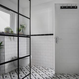 bathroom with frame with black border white metro tiles