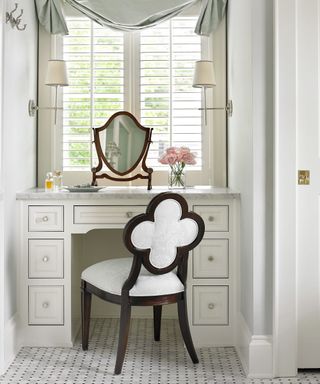 Walk-in wardrobe ideas including an off white dressing table under a window.
