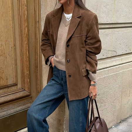 @fakerstrom wearing a suede blazer, jeans, and a sweater