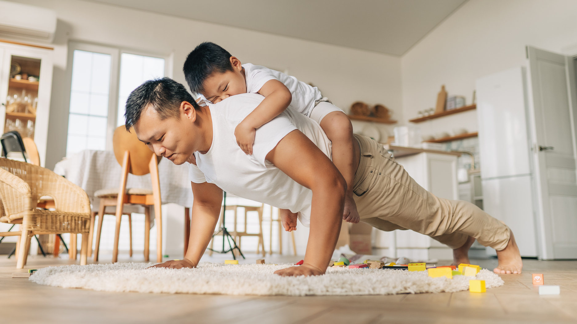 A man who is pushing back at home with his child behind his back