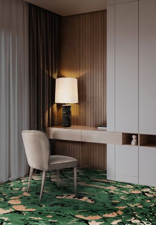 Modern home office with wooden wall slats, green patterned abstract rug and velvet taupe chair