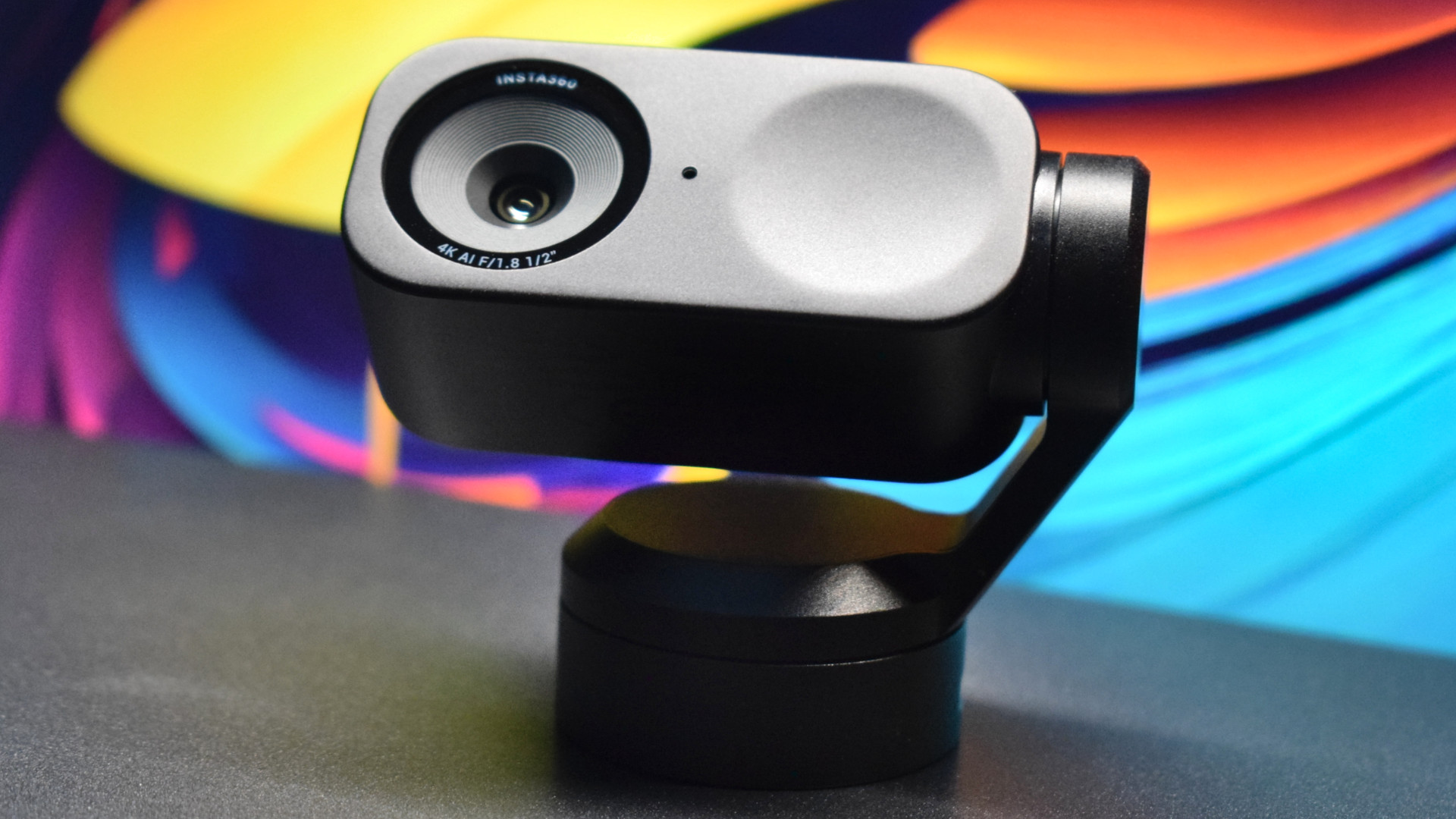 Photo of the Insta360 Link 2 4k webcam showing a front view of the camera, focusing on the layout of its front element.