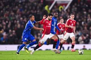 MANCHESTER, ENGLAND - OCTOBER 30: Bruno Fernandes of Manchester United (C) dribbles Boubakary Soumar of Leicester City (R) during the Carabao Cup Fourth Round match between Manchester United and Leicester City at Old Trafford on October 30, 2024 in Manchester, England. (Photo by Will Palmer/Eurasia Sport Images/Getty Images)