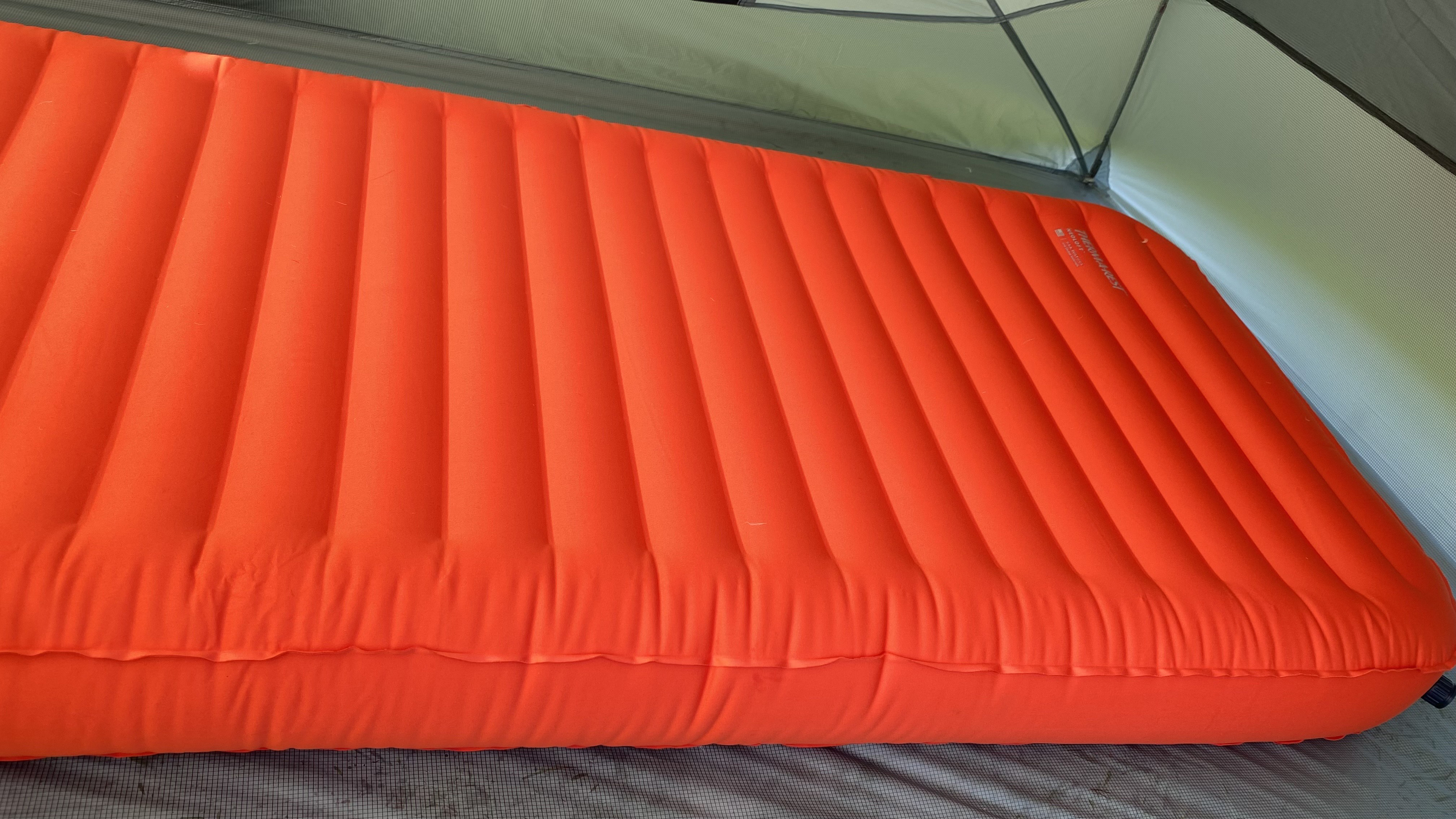 The Therm-a-Rest NeoLoft Sleeping Pad inflated in a tent, showing ridged top and materials