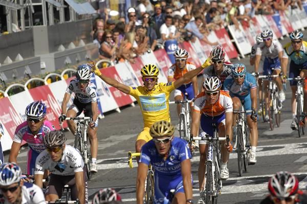 Alberto Contador signals his win as he crosses the finishline