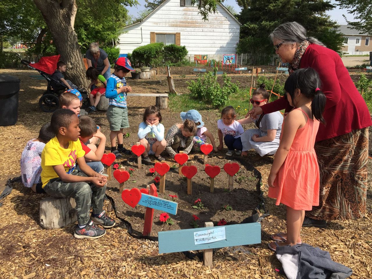 Elder Jenny Spyglass by the project heart garden to honor reconciliation while sharing about her own residential school experience